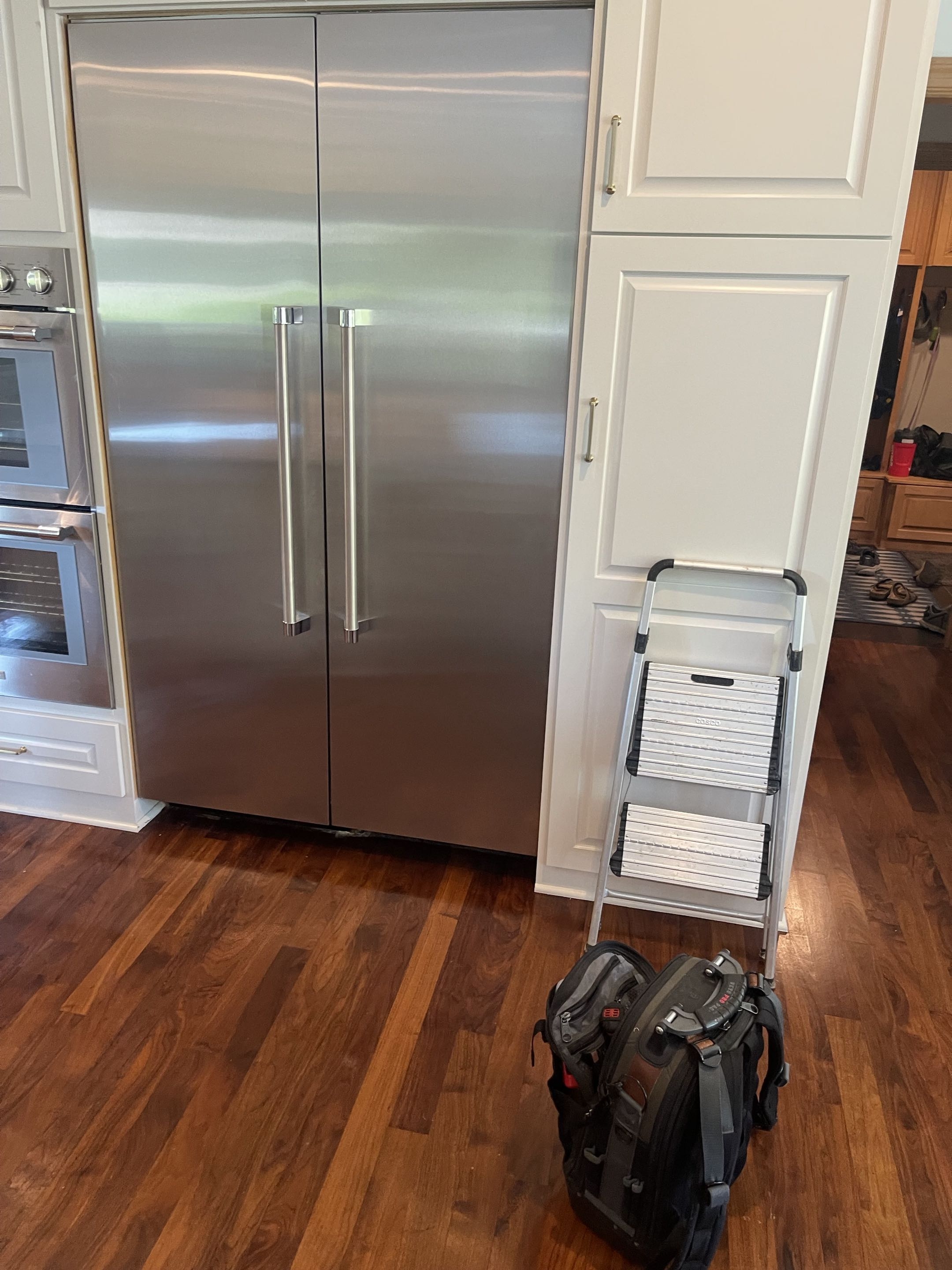 Viking built-in refrigerator repair in a Minneapolis kitchen, with the technician's tools staged in front